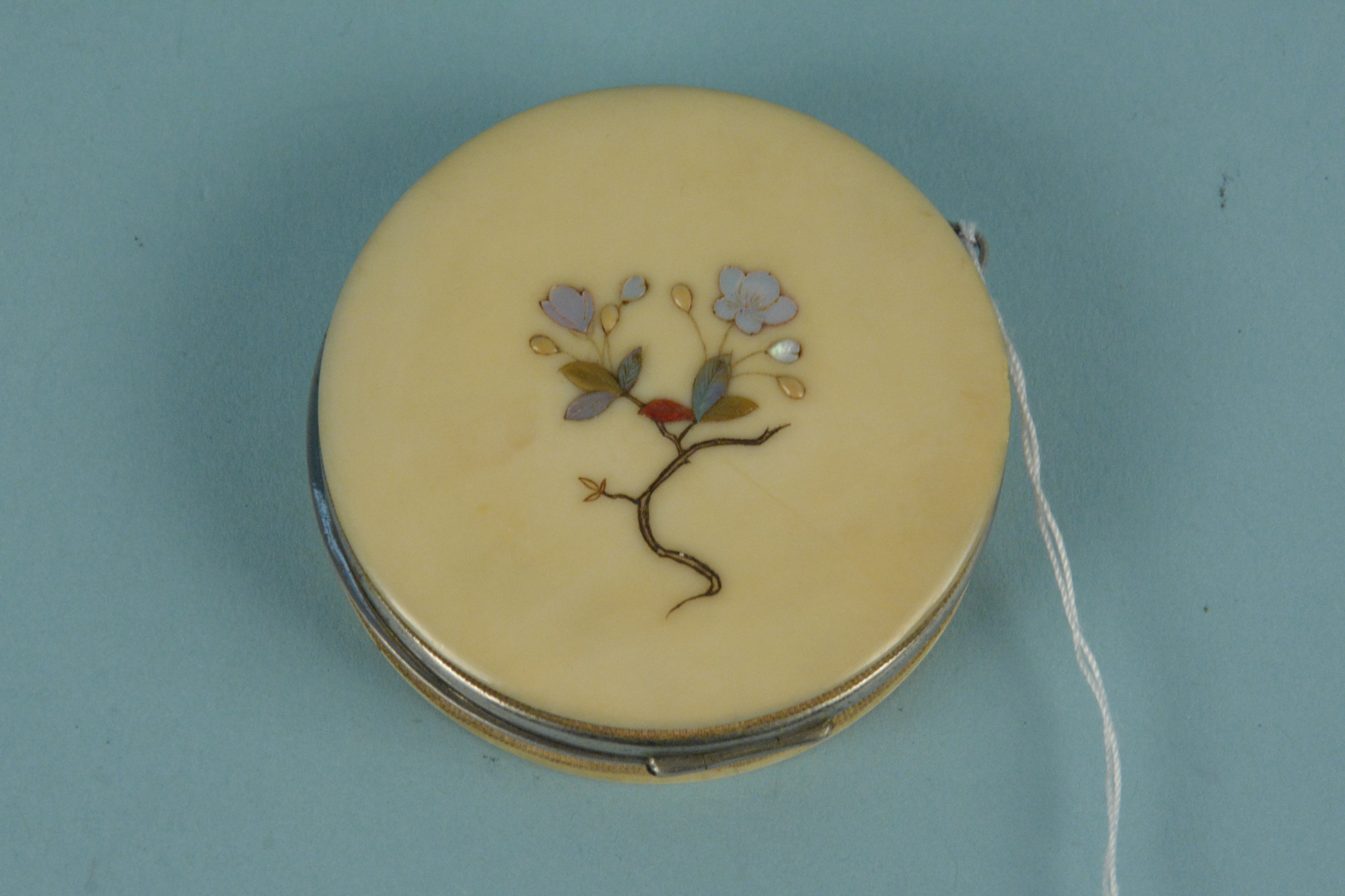 An early 20th Century Japanese ivory and white metal circular purse, - Image 2 of 3