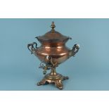 A large twin handled 19th Century copper samovar with brass tap and four spreading feet