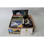 A mixed box of collectors items including coin sets, tea card albums, Days Gone vehicles,
