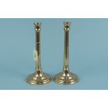 A pair of 18th Century brass candlesticks with fluted stems and engraved circular bases, 25.