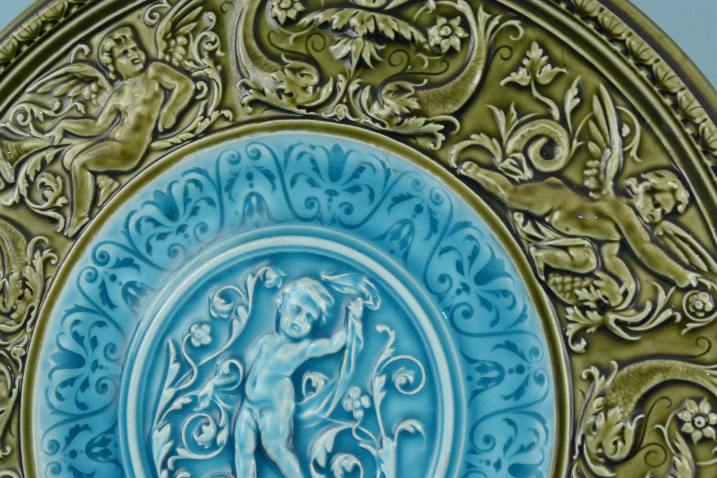 A late 19th Century Austrian Majolica wall plaque with a green moulded border enclosing a central - Image 2 of 3