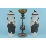 A pair of oriental lidded vases with dark effect figures, Chinese style character marks to base,