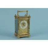 An early 20th Century pierced brass carriage clock, unmarked movement plate,