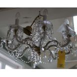 A vintage electrolier pendant eight branch light fitting with cut glass swags and brass fitting,