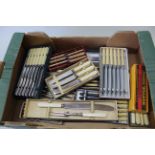 A quantity of boxed sets of silver plated table knives,