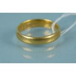 A 22ct gold wedding band, size N,