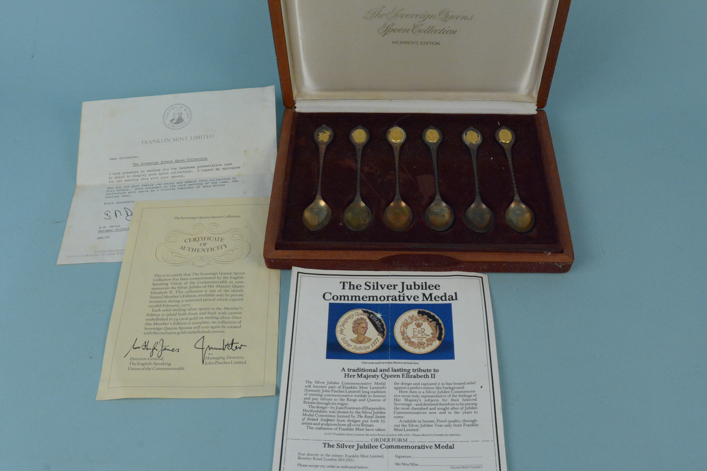 A cased set of six commemorative spoons, titled The Sovereign Queens Spoon Collection,