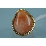 A 9ct gold abstract design ring set with orange hardstone, size K 1/2,