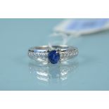 An unmarked white metal sapphire and diamond set ring,