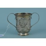 A Georgian silver cup with embossed floral decoration (marks are rubbed), height approx 9cm,
