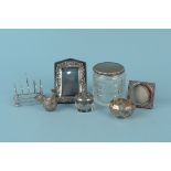 Mixed silver and white metal items including a toast rack, small photograph frames,