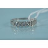 An 18ct white gold five stone diamond ring, the five princess cut diamonds in claw setting, size Q,