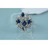 An unmarked white metal sapphire and diamond cluster ring, size M,