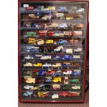 A framed display cabinet with approx seventy eight mainly Lledo collectors cars