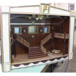 A very large and heavy wooden construction dolls house theatre with giant stair case and