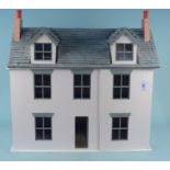 A wooden construction dolls house with a selection of furniture