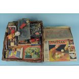 A wicker basket of mixed vintage toys and games including tin plate and wooden wares