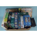 A box of mixed jigsaw puzzles