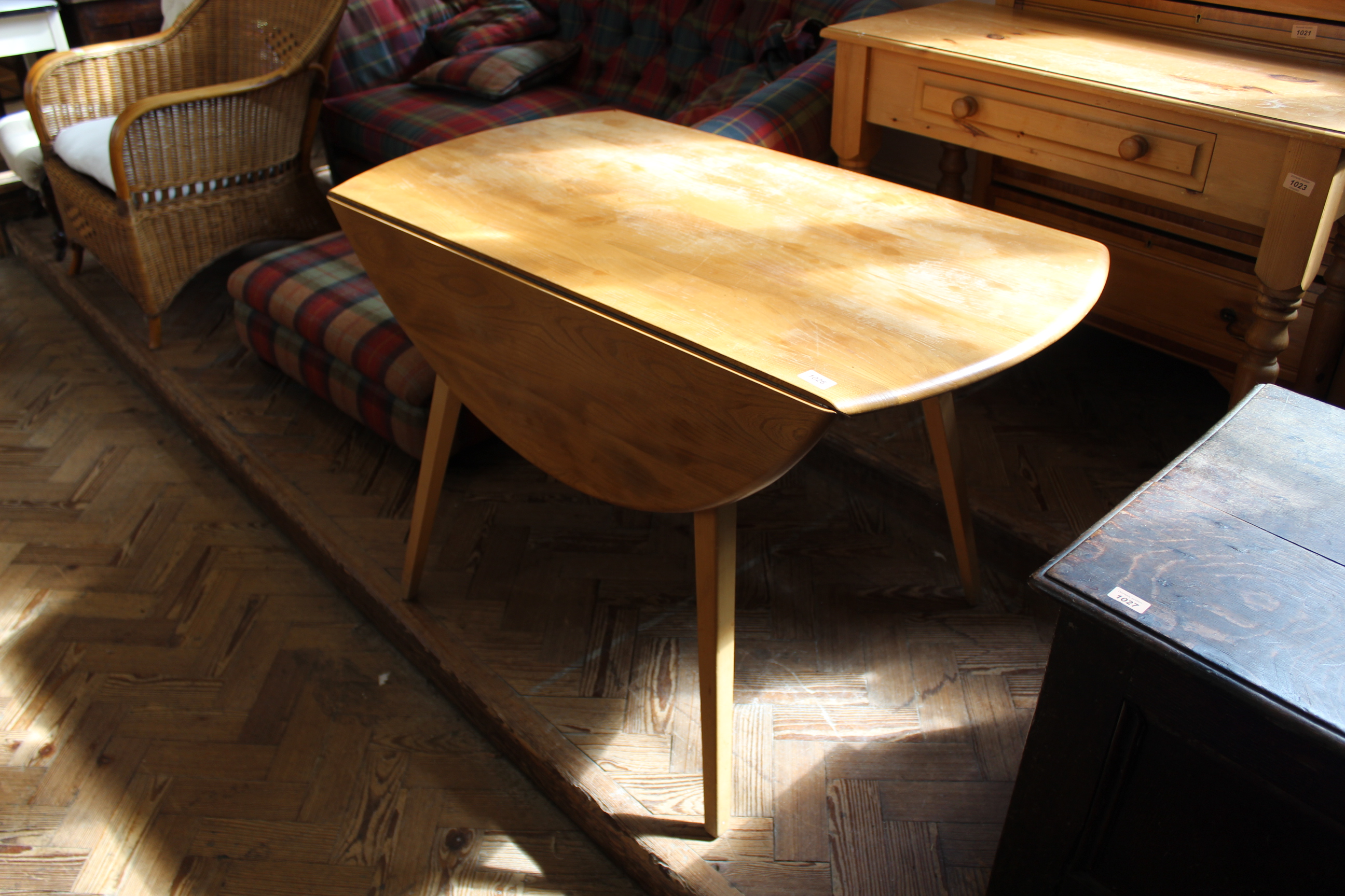 A mid Century Ercol beech and elm drop leaf dining table