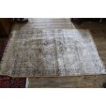 A cream ground rug with central medallion design,