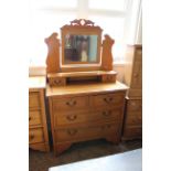 A satin walnut four drawer dressing chest in Edwardian style with mirror