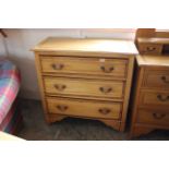 A satin walnut three drawer chest in an Edwardian style