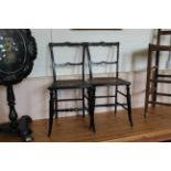 A pair of late 19th Century ebonised chairs with inlaid decoration