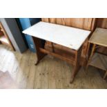 An oak side table with white marble top in Arts and Crafts style
