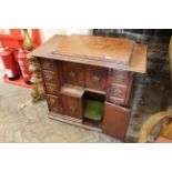 An Edwardian walnut sewing machine cabinet