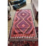 A multi coloured kilim,