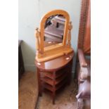 An oval occasional table with four tiers under a hinged top and a pine toilet mirror