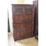 A 20th Century carved oak two door wardrobe