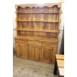 A bespoke hardwood dresser with shelved top and drawer and cupboard base