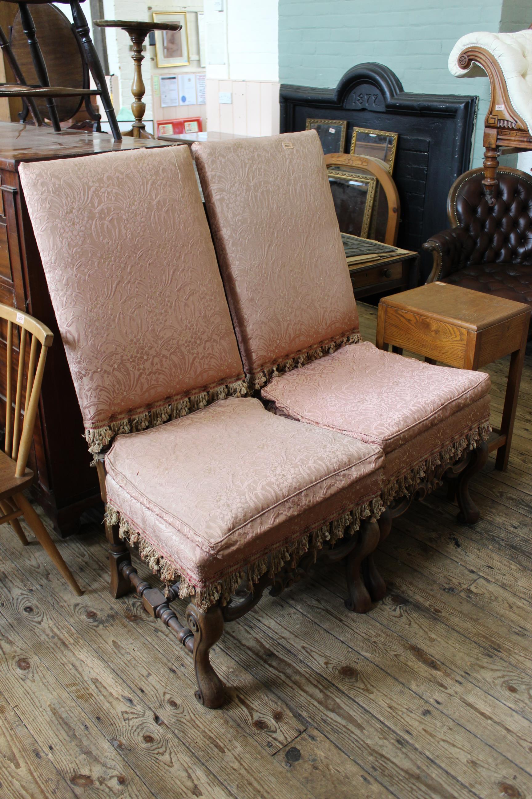 A pair of 19th Century carved walnut upholstered chairs in the William and Mary style
