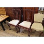 A pair of carved mahogany dining chairs