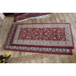 Two red ground machine made rugs