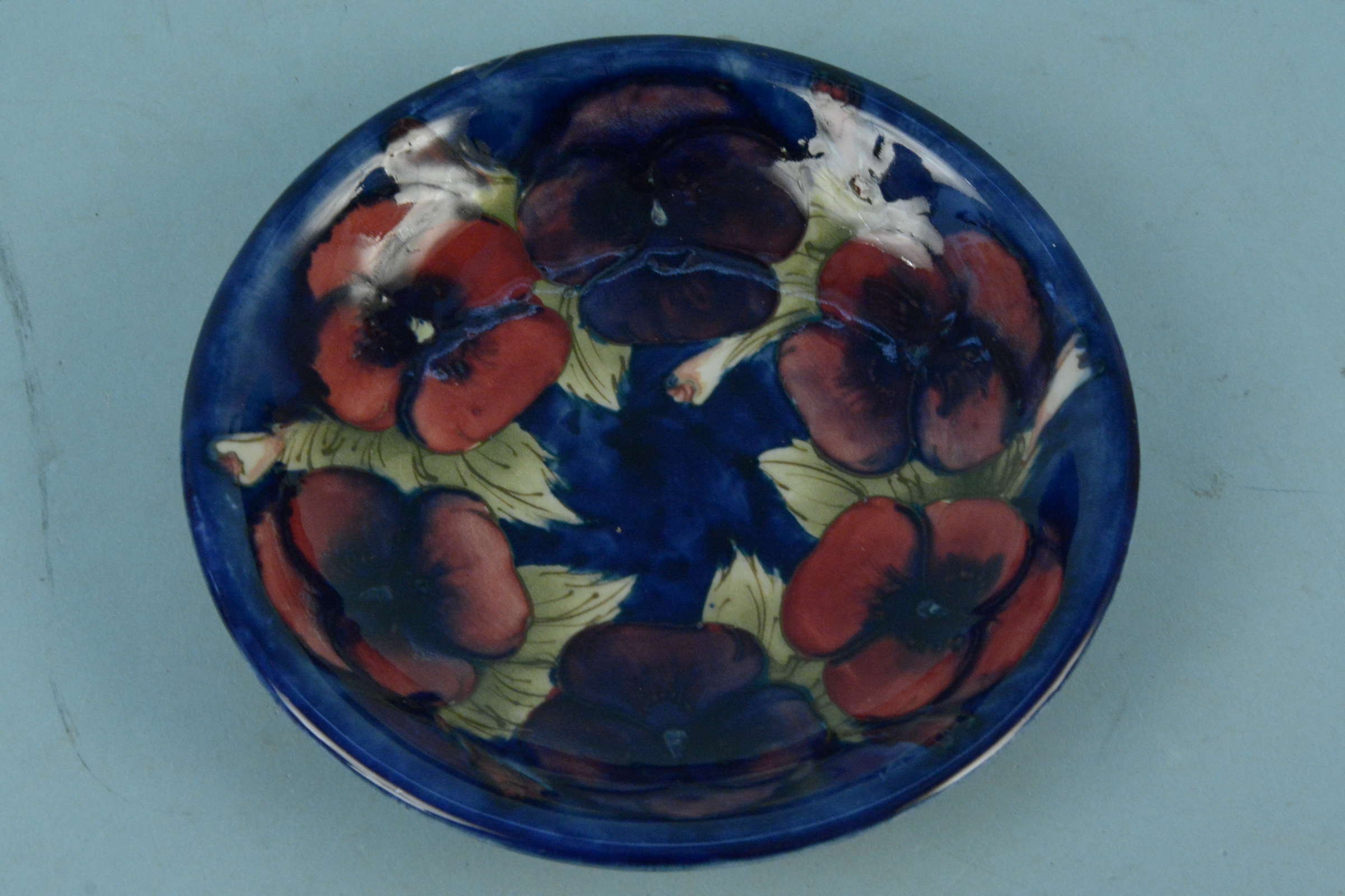 A Moorcroft 'Pansy' pattern shallow dish with blue signature to base, 18.