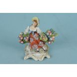 A small Chelsea figurine with flowers (missing one hand)