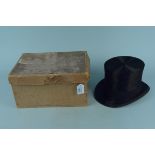 A vintage moleskin top hat with hand brush housed in an Army & Navy card box,