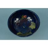 A Moorcroft small bowl, the interior decorated with a blue pansy,