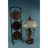 A 20th Century wood and brass three branch table lamp with painted glass shade plus a three tier