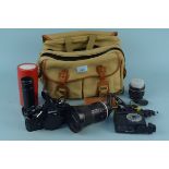 A Nikon 'FE2' camera body together with assorted camera lenses,