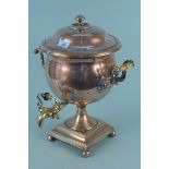 A large Regency twin handled copper samovar with brass tap and circles of engine turned decoration,