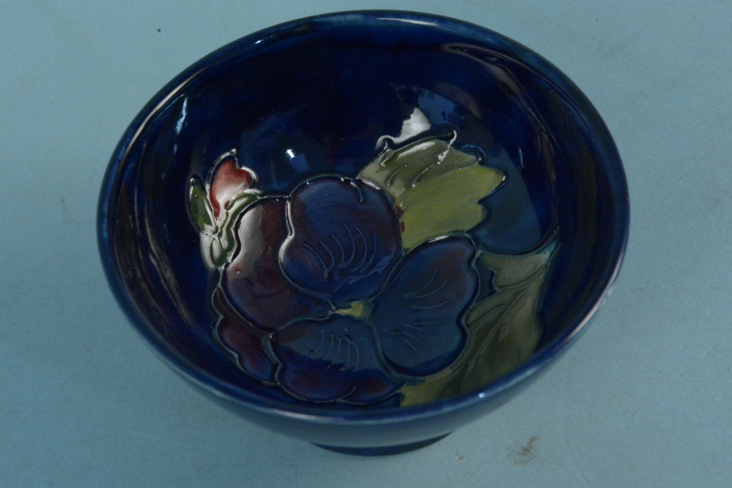 A Moorcroft small bowl, the interior decorated with a blue pansy, - Image 2 of 3