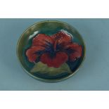 A Moorcroft Hibiscus pattern shallow dish with paper label to base, 11.
