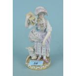 A Meissen figurine of a girl with bird cage