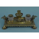 A brass double ink stand with cut glass bottles, detachable candle or taper holder,