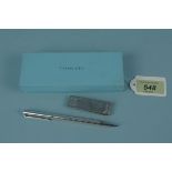 A silver money clip marked Tiffany & Co together with a silver pen marked Tiffany & Co