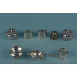 A quantity of white metal items including tea strainer, napkin rings,