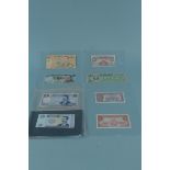 A collection of Old World bank notes including British Armed Forces £1 special vouchers